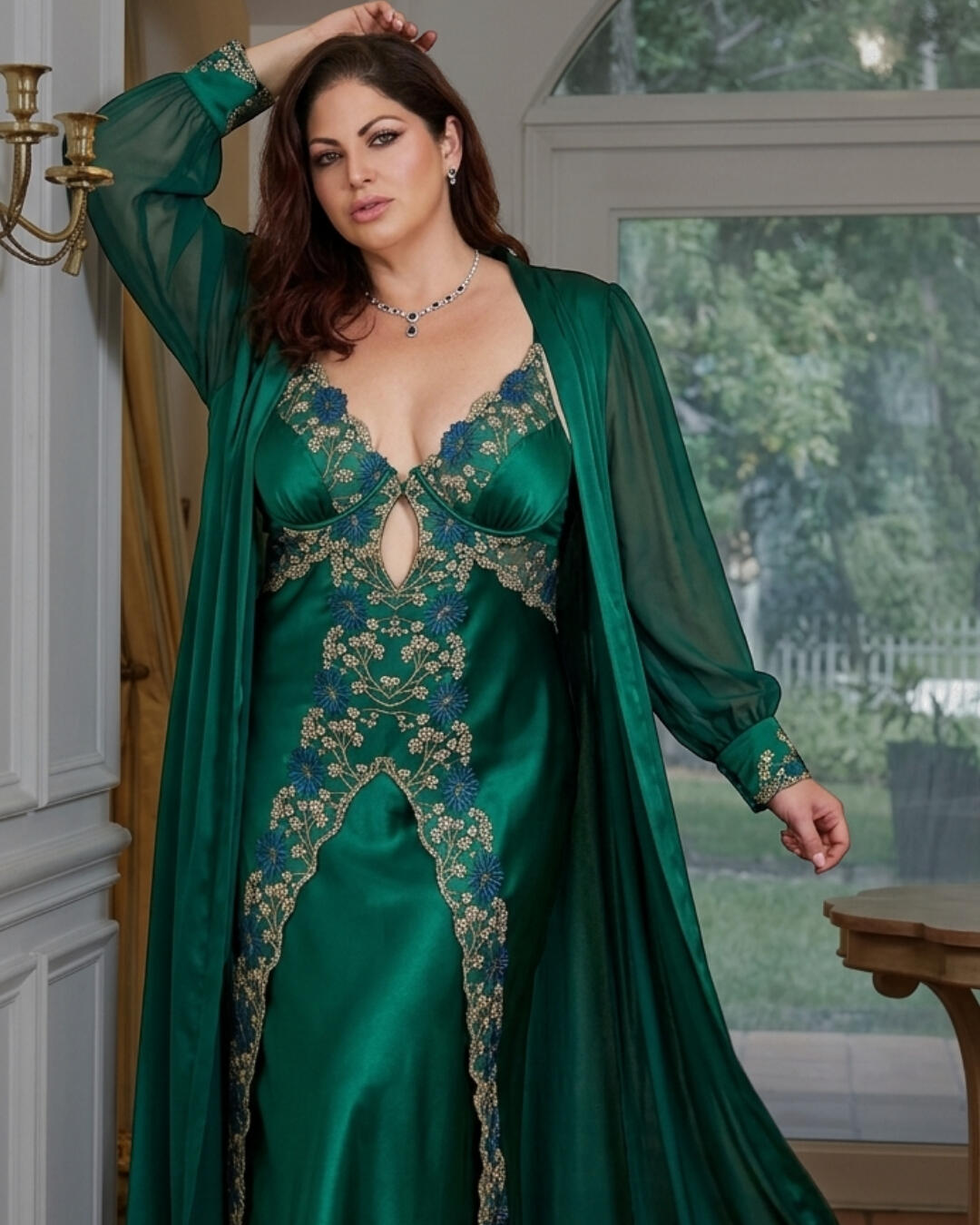 INDOOR-OUTDOOR SYNERGY // Elegant architectural transitions where curated European interiors flow into lush, manicured garden ba A beautiful woman in a luxury emerald green satin and lace gown stands in a white paneled doorway at Sarti Luxe Estates, looking out toward a vibrant green garden.
